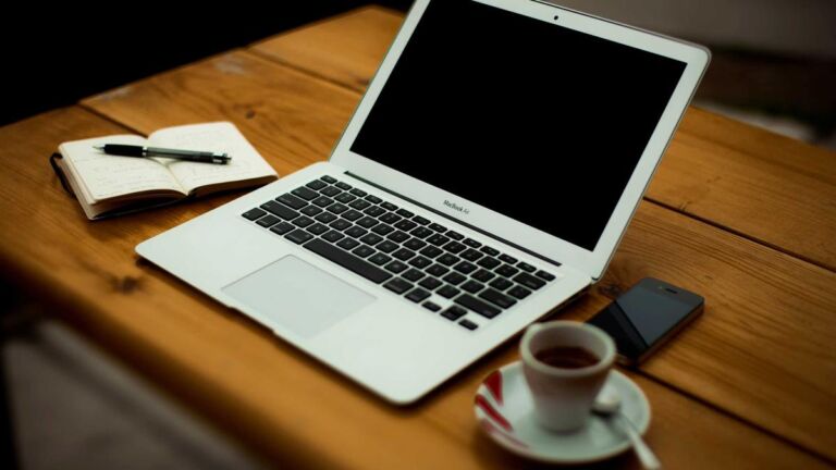 Laptop and notebook on a desk