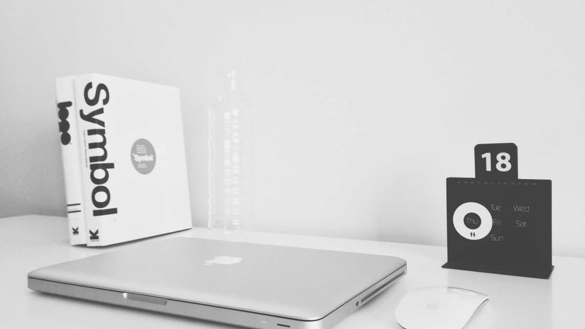 Laptop with a product box on a white desk